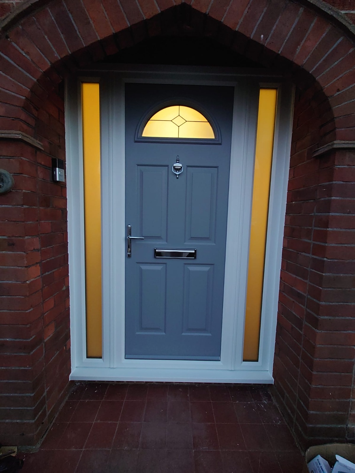 Composite front door fitted by HDS, lit up at dusk